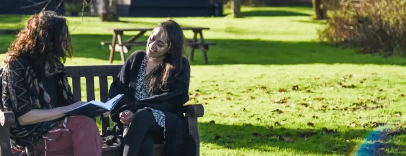 Women chatting on bench