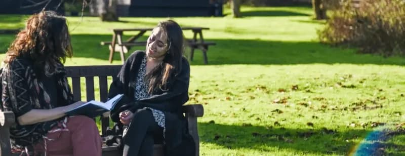 Women chatting on bench