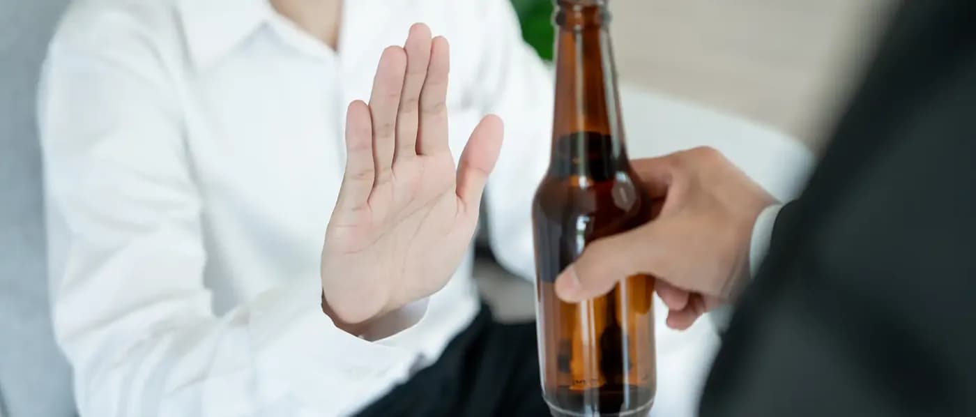 Man say no avoid drink alcohol hand.
