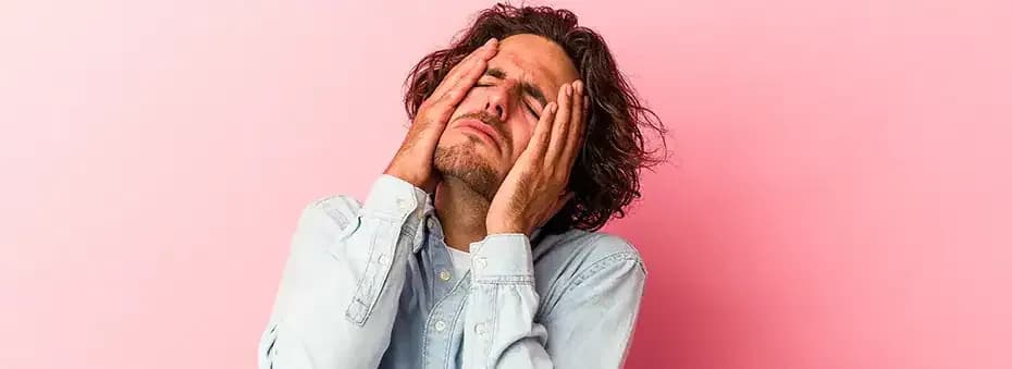 Man with hands on face