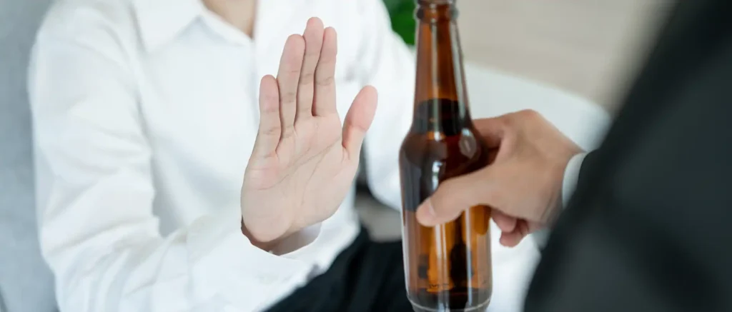 Man say no avoid drink alcohol hand.